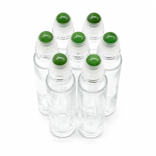 Six clear glass rollerball bottles with green adventurine gemstone, arranged in a cluster on a white background.