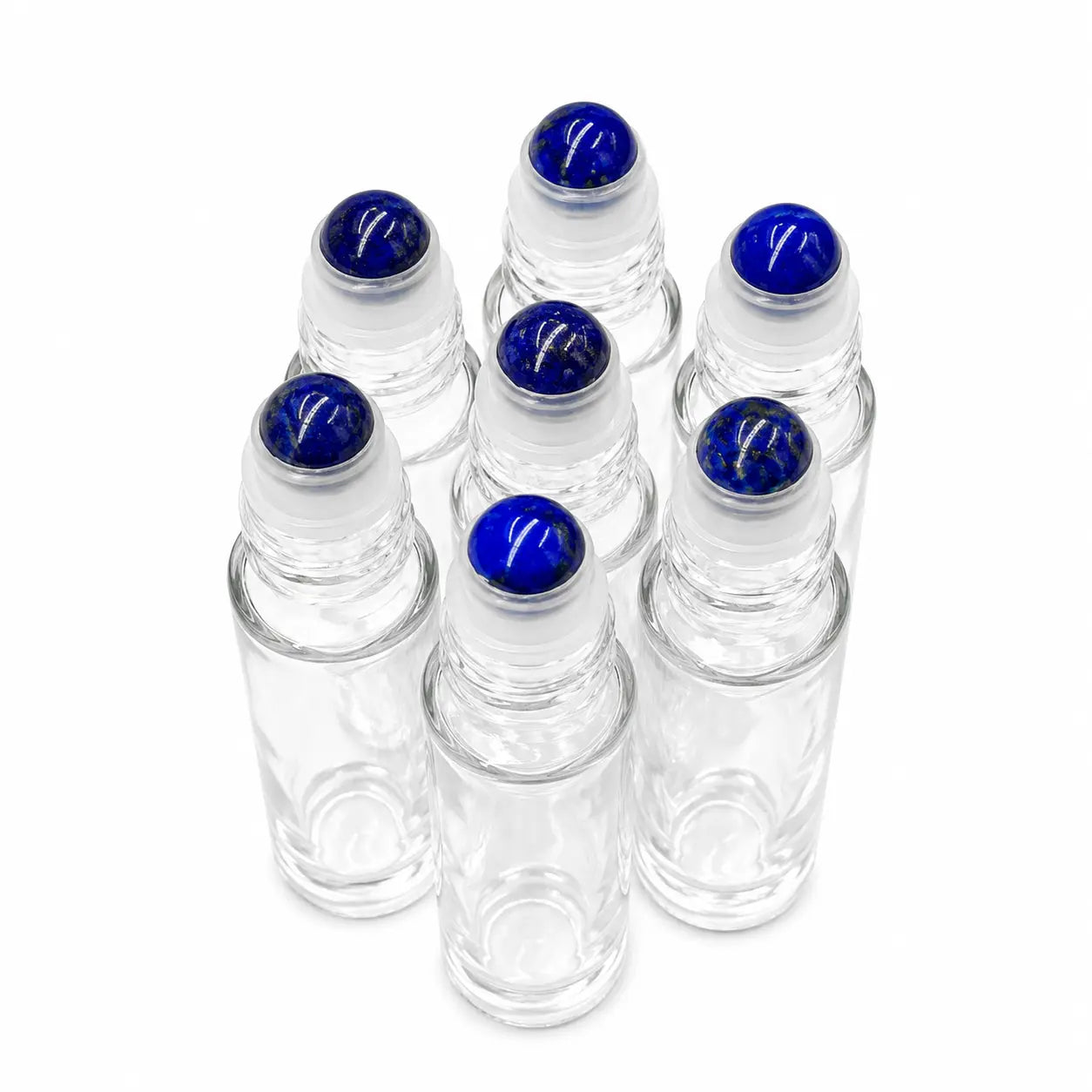 Six clear glass rollerball bottles with lapis lazuli gemstone rollerball arranged in a cluster on a white background.