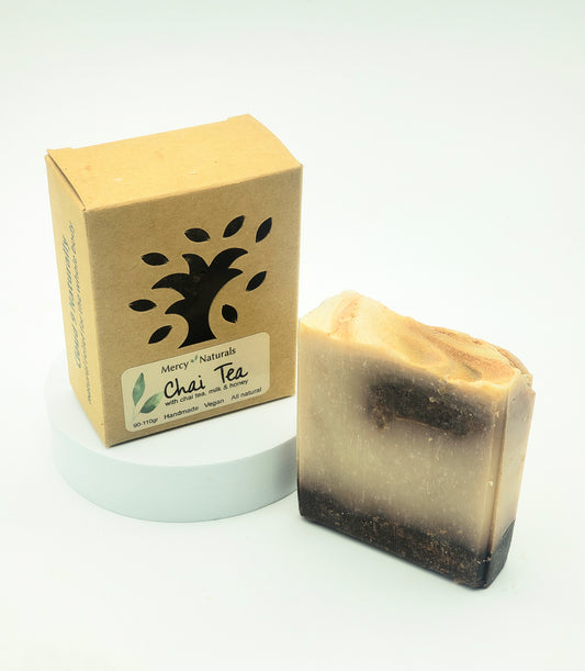 Bar of Chai Tea soap next to its packaging on a white background