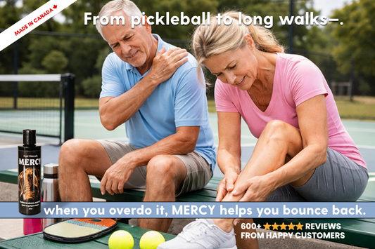 aSenior couple sitting on bench rubbing sore muscles with a bottle of Mercy pain relief in the foreground.