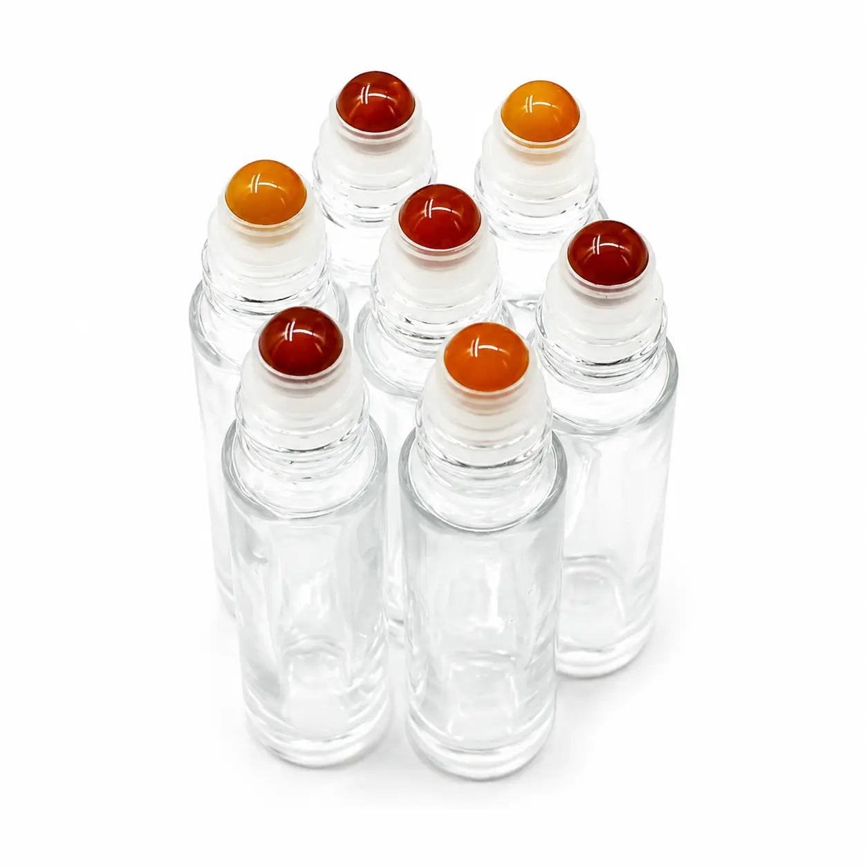 Six clear glass roller bottles with Carnelian round roller balls in red, orange, and yellow, arranged on a white background.
