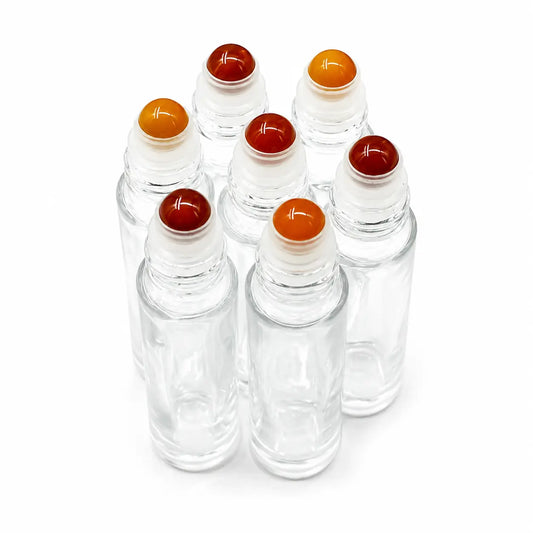 Six clear glass roller bottles with Carnelian round roller balls in red, orange, and yellow, arranged on a white background.