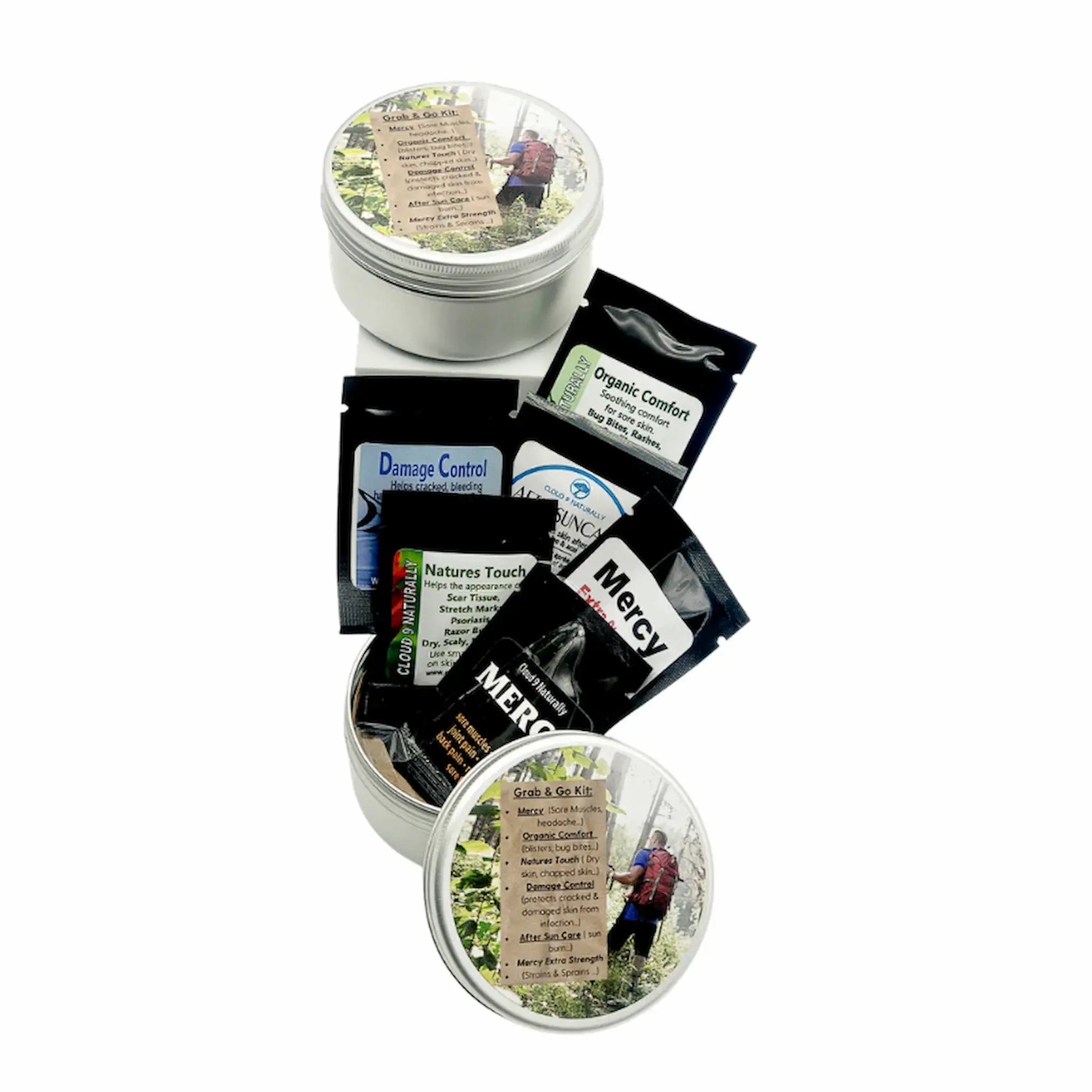 a small metal tin with samples of Mercy, Organic Comfort, Damage Control natures Touch white background