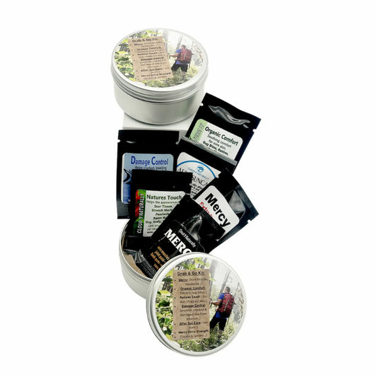 a small metal tin with samples of Mercy, Organic Comfort, Damage Control natures Touch white background