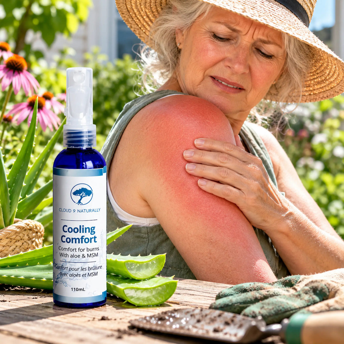A woman in a straw hat outdoors holds her sore shoulder while a blue spray bottle labeled Cloud 9 Naturally Cooling Comfort stands on a wooden table beside aloe vera and gardening gloves.