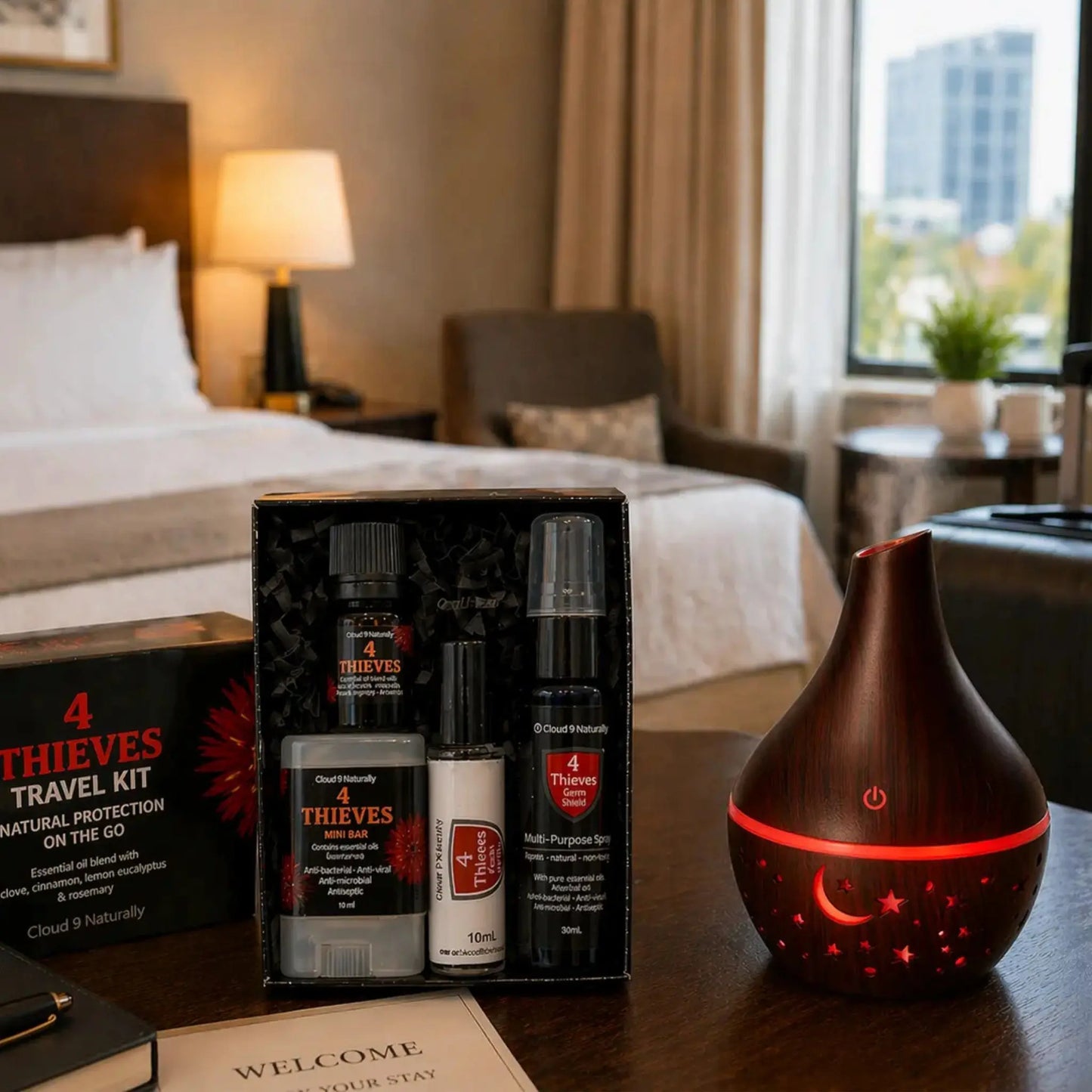 Dark wood diffuser in hotel room with 4 thieves travel set