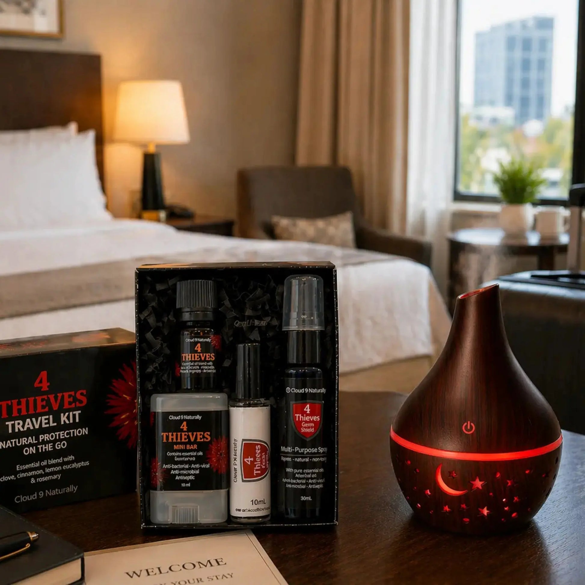Dark wood diffuser in hotel room with 4 thieves travel set