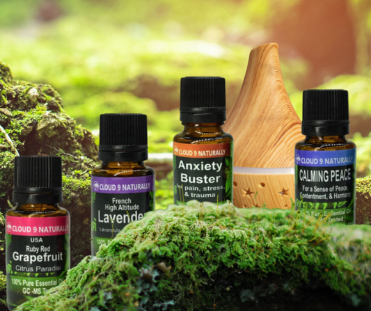 four different essential oils, lavender, anxiety buster, grapefruit, and calming peace  in 5ml glass bottles.