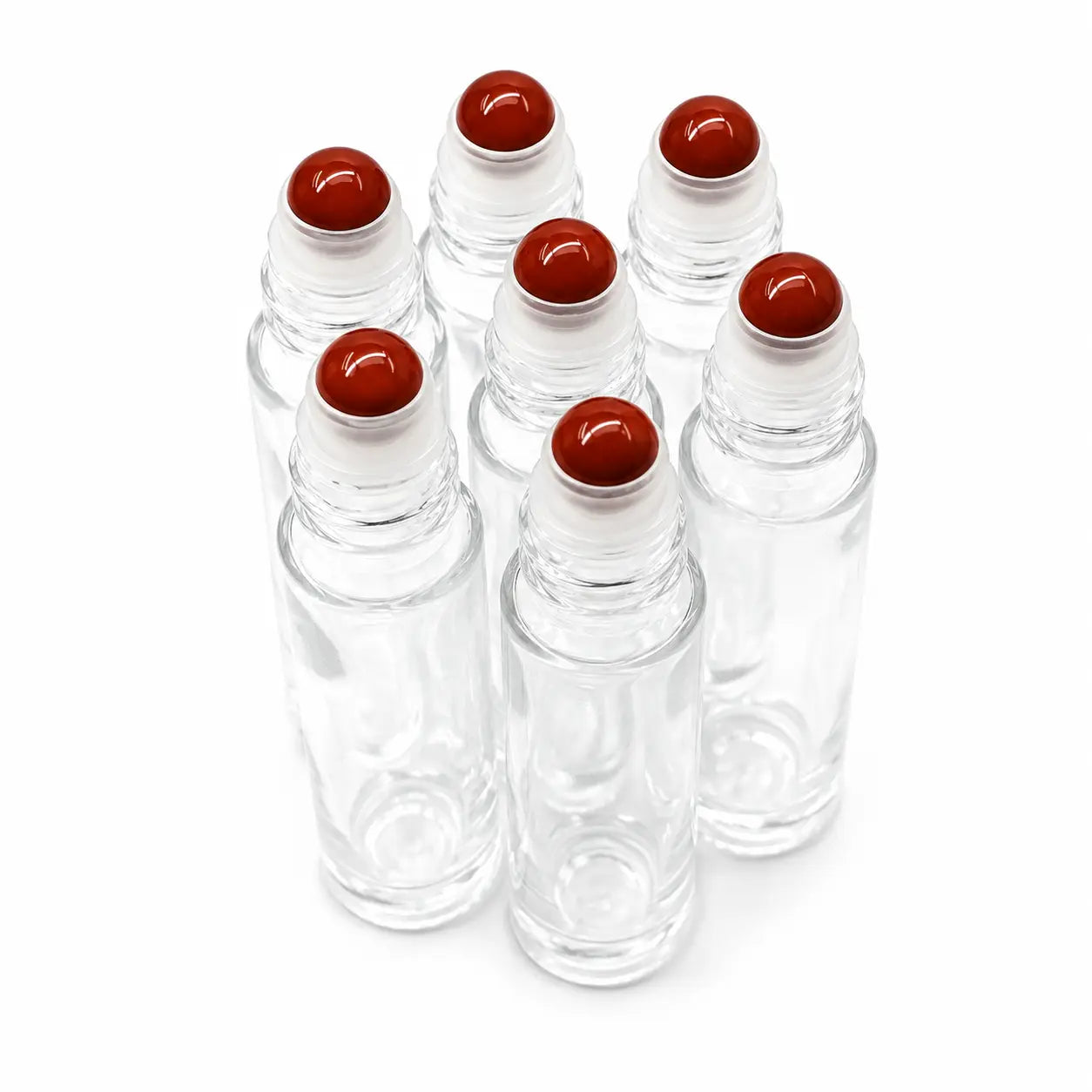 Six clear glass roller bottles with white collars and red jasper gemstone roller balls, arranged on a white background.