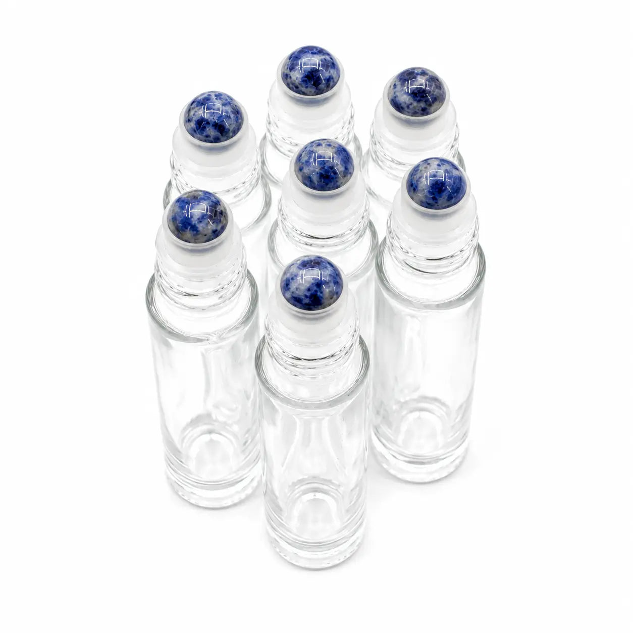 Six clear glass roller bottles with blue and white speckled sodalite gemstone stone rollerballs, arranged in a cluster on a white background.