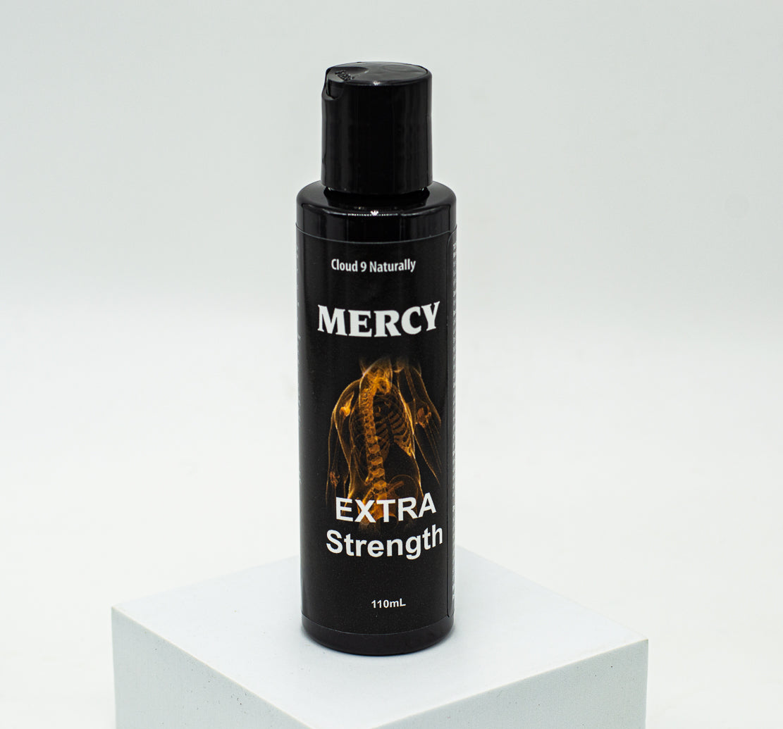 Mercy Extra strength 110ml black plastic bottle with flip top,  label has a picture of an orange colored spine skelaton with white lettering.