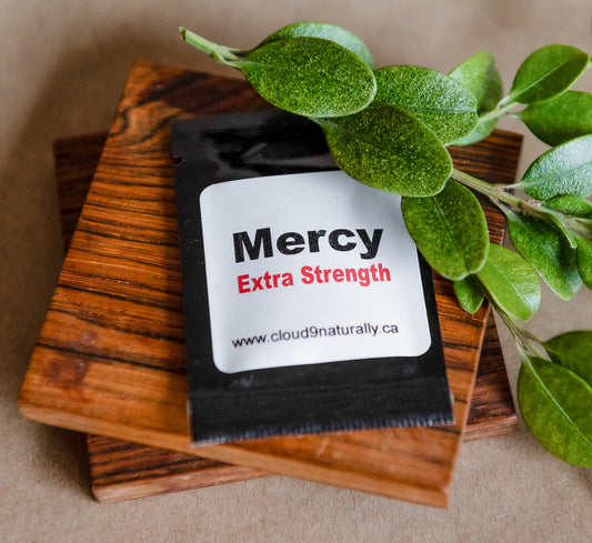 Mercy Extra Strenght Small square foil sample pack with white label and black and red lettering.